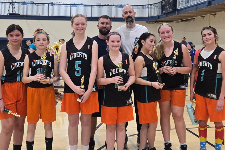 Female high school basketball team playing game